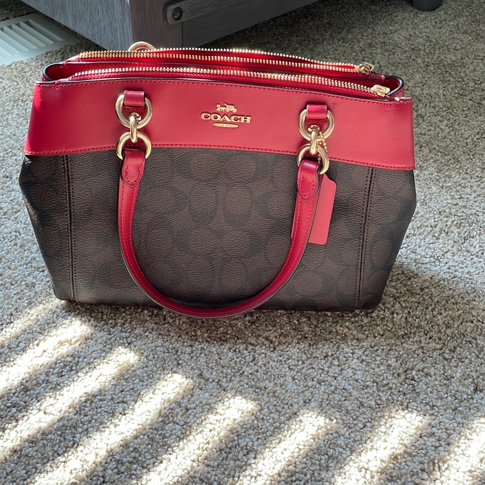 Red and brown coach purse also has shoulder strap